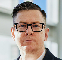 Alexander Hughes Porträt als CEO und Geschäftsführer eines Krypto-Handelsunternehmens